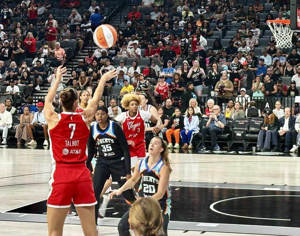 Las Vegas Aces forward Stephanie Talbot hits a corner three over New York's Sabrina Ionescu to open the scoring at Michelob ULTRA Arena on Thursday, July 30.