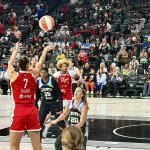 Las Vegas Aces forward Stephanie Talbot hits a corner three over New York's Sabrina Ionescu to open the scoring at Michelob ULTRA Arena on Thursday, July 30.