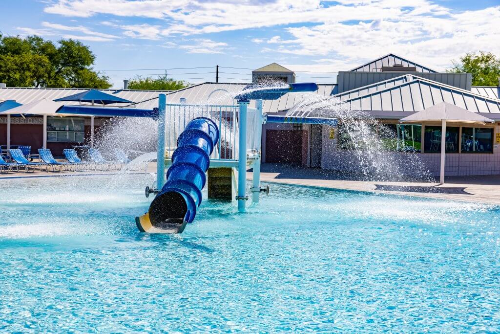 The Silver Mesa Park pool offers a water slide and children's play area.